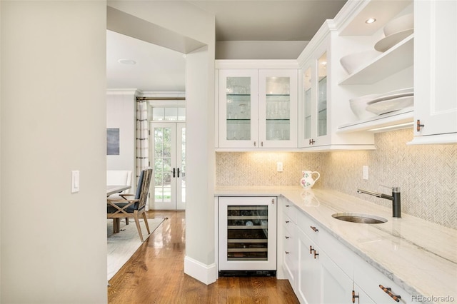 5425 S University Blvd, Greenwood Village, CO 80121 - bar area featuring wine cooler, a sink, dark wood-type flooring, french doors, and tasteful backsplash