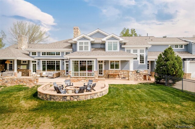 5425 S University Blvd, Greenwood Village, CO 80121 - back of property featuring an outdoor living space with a fire pit, a patio area, stone siding, a chimney, and a shingled roof