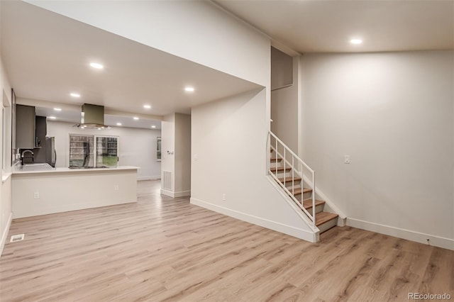 4714 S Simms Ct, Morrison, CO 80465 - unfurnished living room featuring light wood-type flooring, stairway, and recessed lighting
