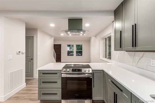 4714 S Simms Ct, Morrison, CO 80465 - kitchen with stainless steel range with electric stovetop, ventilation hood, a peninsula, light countertops, and recessed lighting