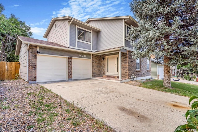18751 E Mexico Ave, Aurora, CO 80017 - view of front of property featuring concrete driveway, brick siding, and a garage