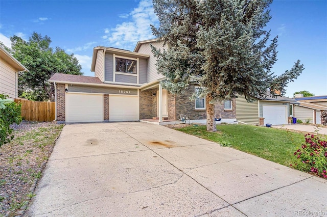 18751 E Mexico Ave, Aurora, CO 80017 - view of front facade featuring concrete driveway, brick siding, and a garage