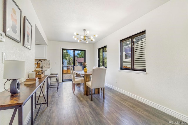 18751 E Mexico Ave, Aurora, CO 80017 - dining room featuring a chandelier and dark wood finished floors