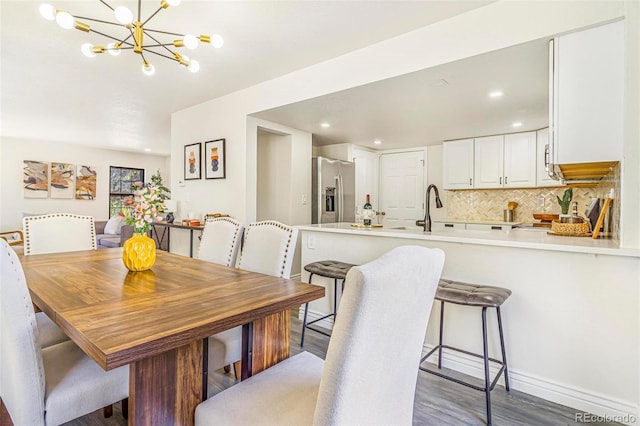 18751 E Mexico Ave, Aurora, CO 80017 - dining area with a chandelier, wood finished floors, and recessed lighting
