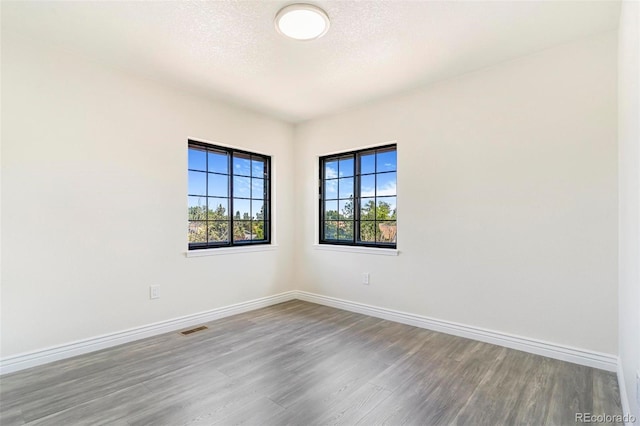 18751 E Mexico Ave, Aurora, CO 80017 - empty room featuring wood finished floors and baseboards