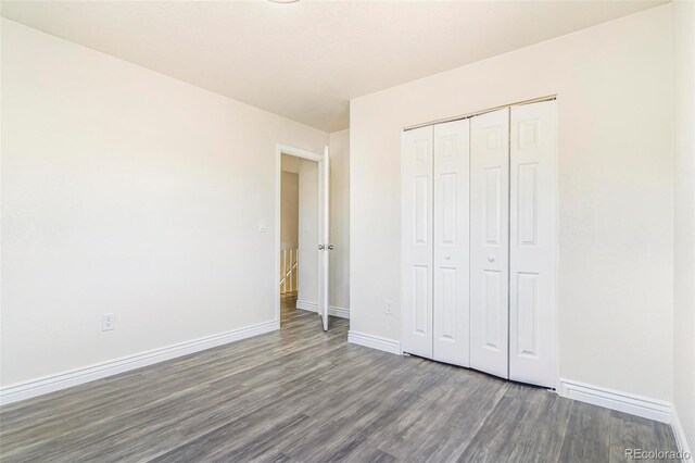 18751 E Mexico Ave, Aurora, CO 80017 - unfurnished bedroom featuring wood finished floors and a closet