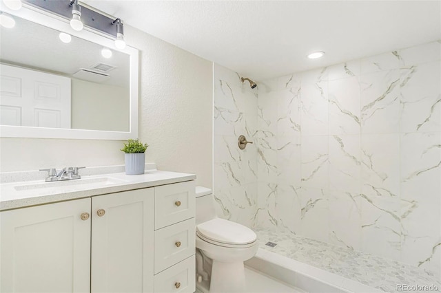 18751 E Mexico Ave, Aurora, CO 80017 - bathroom with a marble finish shower, vanity, and a textured wall
