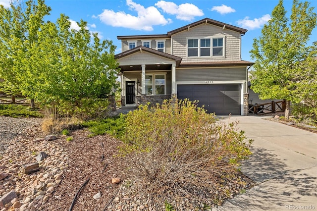 8216 Mahogany Wood Ct, Colorado Springs, CO 80927 - craftsman house featuring an attached garage, driveway, covered porch, and stone siding