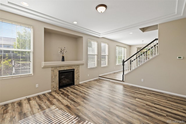 8216 Mahogany Wood Ct, Colorado Springs, CO 80927 - unfurnished living room featuring stairs, wood finished floors, baseboards, a tiled fireplace, and recessed lighting