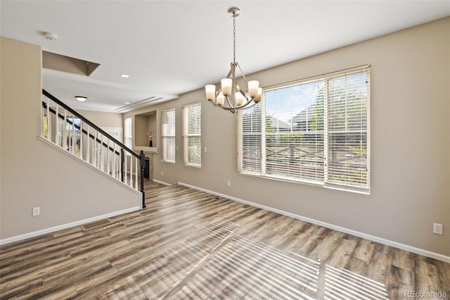 8216 Mahogany Wood Ct, Colorado Springs, CO 80927 - spare room with a chandelier, wood finished floors, baseboards, stairs, and a smoke detector