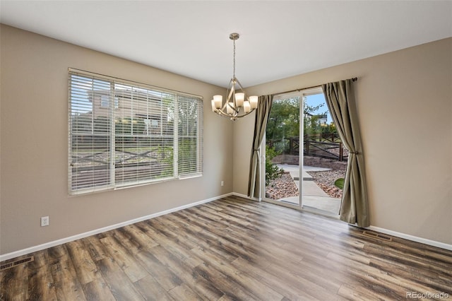 8216 Mahogany Wood Ct, Colorado Springs, CO 80927 - spare room with a chandelier, wood finished floors, and baseboards