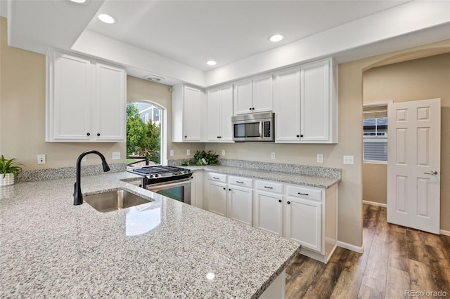 8216 Mahogany Wood Ct, Colorado Springs, CO 80927 - kitchen featuring a sink, appliances with stainless steel finishes, white cabinetry, light stone countertops, and recessed lighting