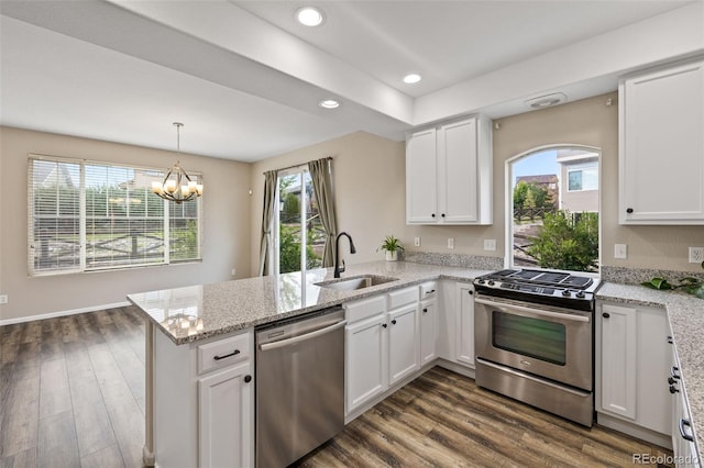 8216 Mahogany Wood Ct, Colorado Springs, CO 80927 - kitchen featuring stainless steel appliances, a sink, a peninsula, white cabinets, and recessed lighting