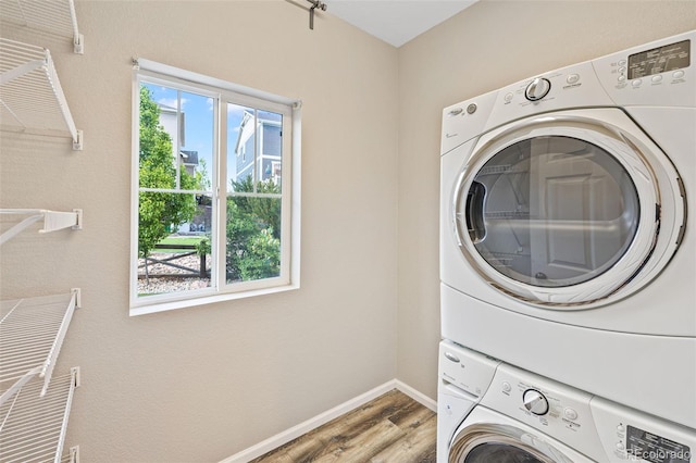 8216 Mahogany Wood Ct, Colorado Springs, CO 80927 - laundry room with stacked washing machine and dryer, wood finished floors, and baseboards
