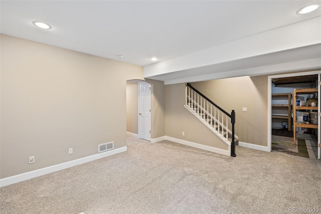 8216 Mahogany Wood Ct, Colorado Springs, CO 80927 - finished basement with carpet, baseboards, stairs, arched walkways, and recessed lighting