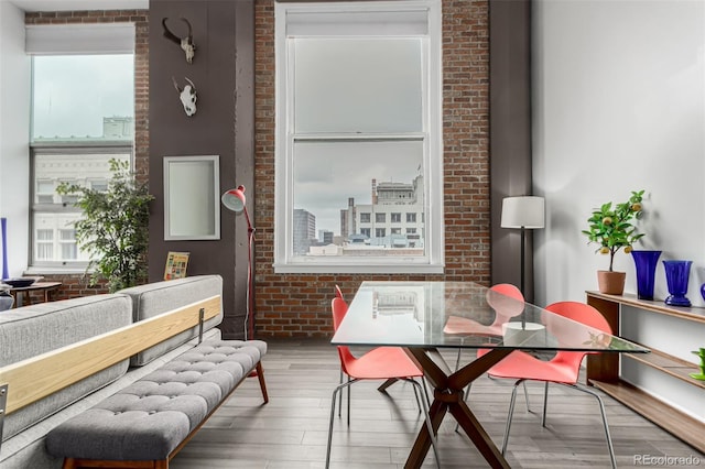 interior space with brick wall and wood finished floors