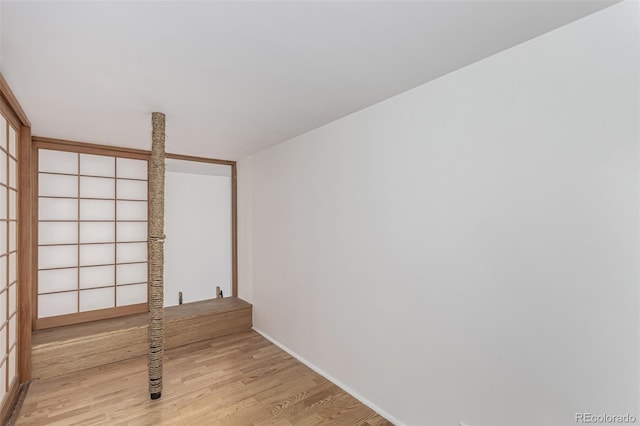 spare room featuring light wood-style floors