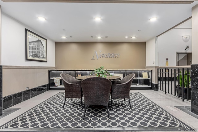 dining room with wainscoting, recessed lighting, and marble finish floor