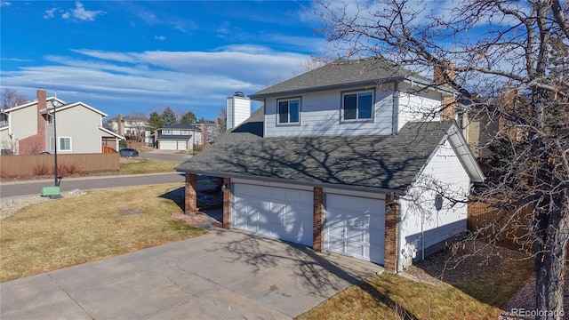 view of side of home featuring a lawn and a garage