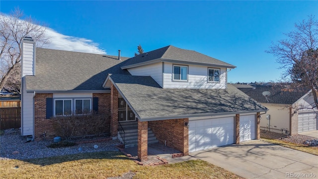 view of property featuring a garage and a front lawn