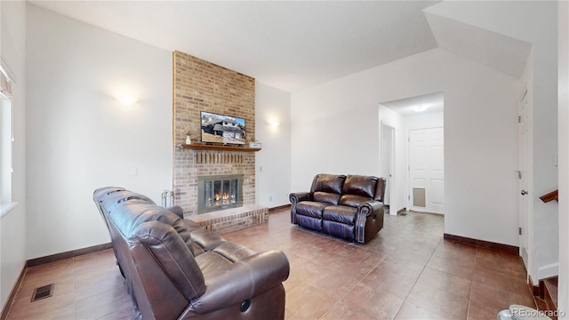 living room with a fireplace and vaulted ceiling