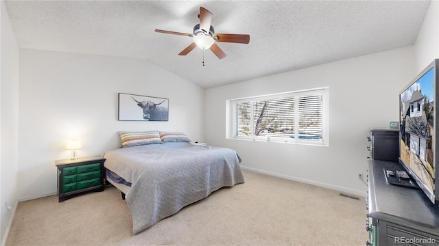 carpeted bedroom featuring a textured ceiling, ceiling fan, and vaulted ceiling