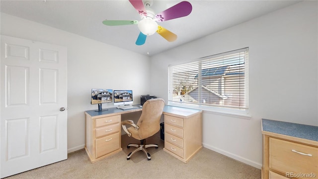 office space featuring ceiling fan and light carpet