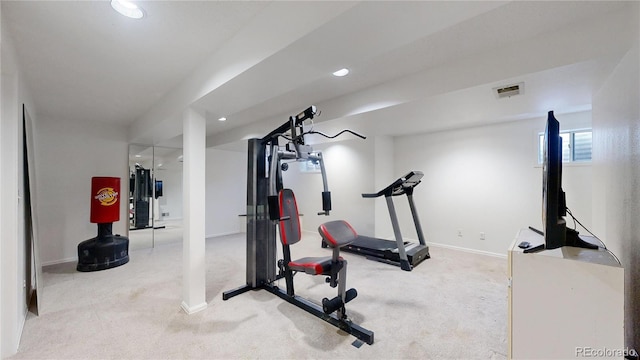 workout room featuring light carpet