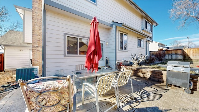 view of patio with central air condition unit and area for grilling