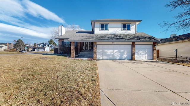 view of front property featuring a garage and a front yard