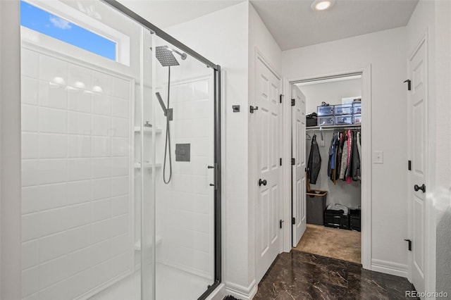 10226 Worchester St, Commerce City, CO 80022 - bathroom featuring a walk in closet, a shower stall, marble finish floor, and recessed lighting