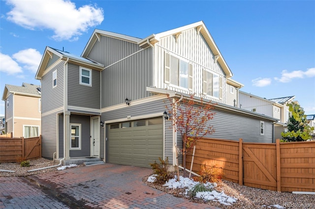 10226 Worchester St, Commerce City, CO 80022 - view of front of property with a garage, board and batten siding, fence, a gate, and decorative driveway