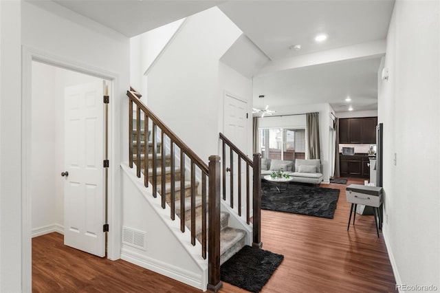 10226 Worchester St, Commerce City, CO 80022 - staircase with a chandelier, visible vents, baseboards, and wood finished floors