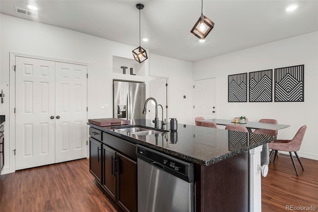 10226 Worchester St, Commerce City, CO 80022 - kitchen with decorative light fixtures, appliances with stainless steel finishes, dark wood-style flooring, and a sink