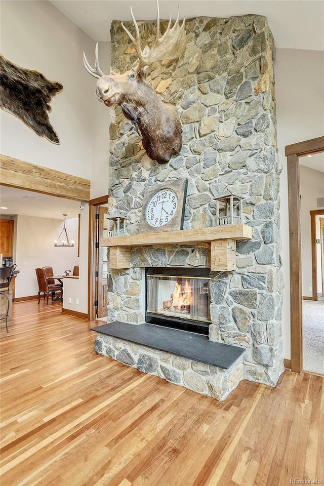 room details featuring hardwood / wood-style flooring and a stone fireplace