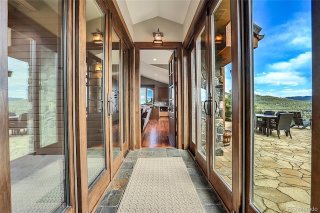 hall featuring a mountain view, french doors, and vaulted ceiling