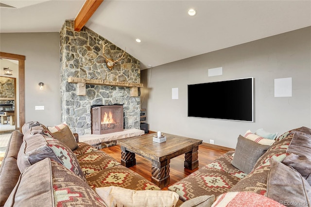 living room featuring hardwood / wood-style flooring, vaulted ceiling with beams, and a fireplace