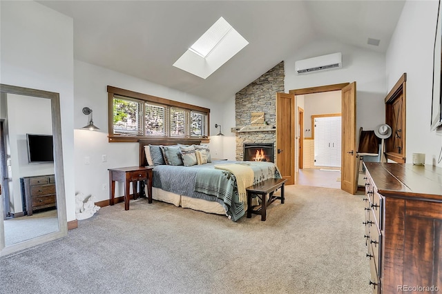 carpeted bedroom featuring an AC wall unit, a skylight, a fireplace, and high vaulted ceiling