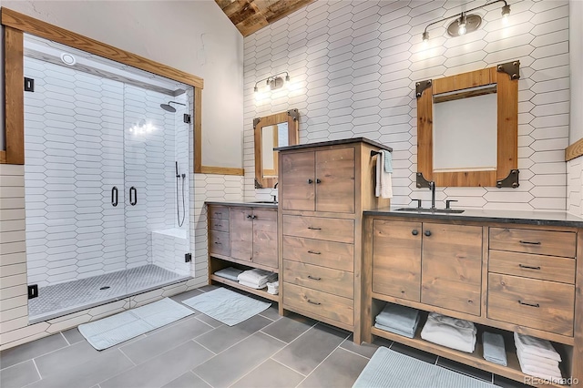 bathroom with vanity, a shower with door, tile patterned floors, tile walls, and wood ceiling