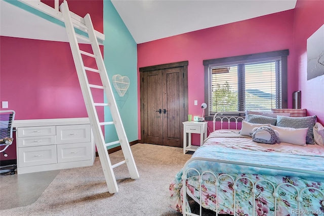 carpeted bedroom with vaulted ceiling