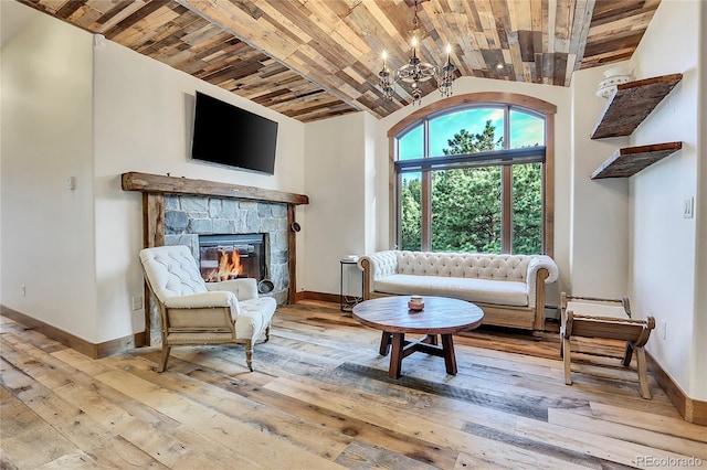 sitting room with a fireplace, a chandelier, and light hardwood / wood-style flooring