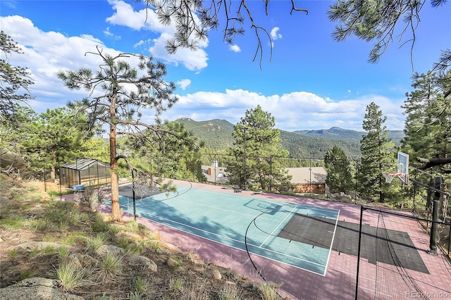 view of basketball court with a mountain view