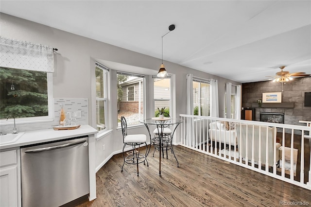 10571 Garfield St, Thornton, CO 80233 - dining space with healthy amount of natural light, wood finished floors, ceiling fan, and a glass covered fireplace