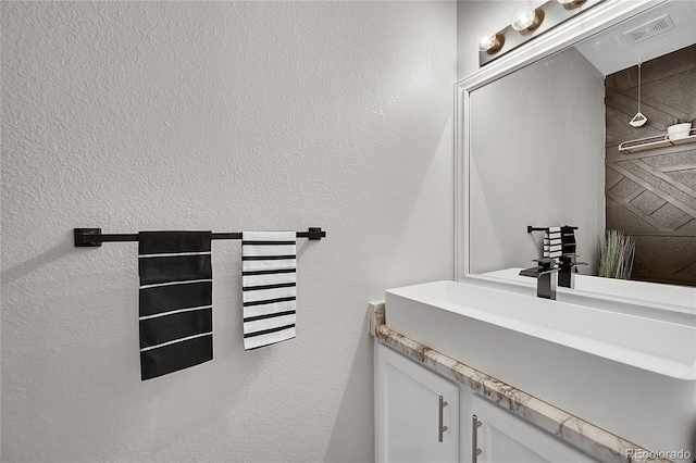 10571 Garfield St, Thornton, CO 80233 - bathroom with vanity and a textured wall