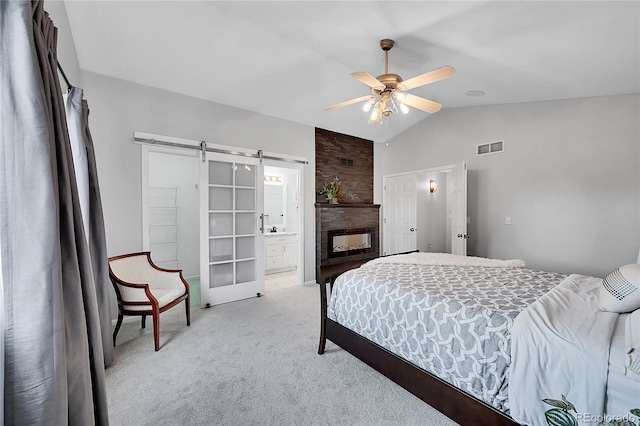 10571 Garfield St, Thornton, CO 80233 - bedroom with light colored carpet, vaulted ceiling, a barn door, ensuite bathroom, and ceiling fan