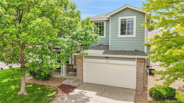 10571 Garfield St, Thornton, CO 80233 - view of front facade featuring a shingled roof, brick siding, a garage, and concrete driveway