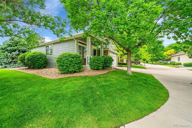10571 Garfield St, Thornton, CO 80233 - view of front of house featuring a front lawn, a garage, and driveway