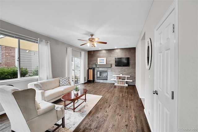10571 Garfield St, Thornton, CO 80233 - living room with ceiling fan, dark wood-type flooring, a large fireplace, baseboards, and recessed lighting