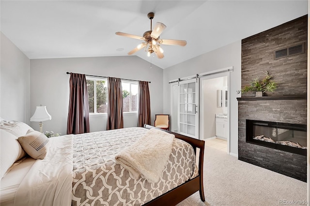 10571 Garfield St, Thornton, CO 80233 - bedroom with vaulted ceiling, a barn door, carpet floors, a fireplace, and ceiling fan