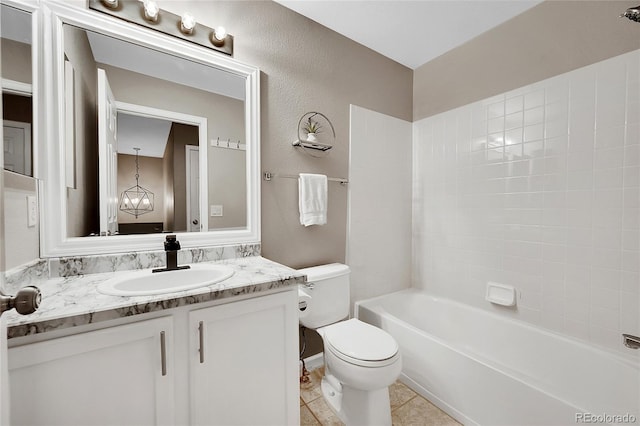 10571 Garfield St, Thornton, CO 80233 - full bath featuring toilet, vanity, tile patterned flooring, a textured wall, and washtub / shower combination
